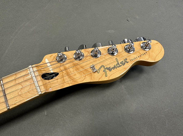 Fender Telecaster maple neck and headstock with chrome tuning pegs on gray background
