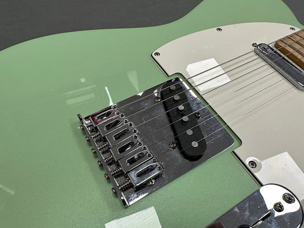 Close-up of green electric guitar body showing white pickguard, chrome bridge, and single-coil pickup at Coffee House Guitars product listing