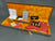 Fender vintage electric guitar in red with tortoiseshell pickguard and three single-coil pickups in open brown hard case with orange plush interior, including Fender certificate of authenticity and manuals.