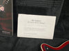 RS Guitars RS Classic Owners Manual displayed in guitar case with part of red guitar body and Brian May book visible