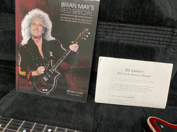 Brian May's Red Special guitar book and RS Classic Owners Manual inside guitar case with part of guitar neck and body visible