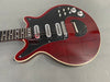 Cherry red electric guitar with black pickguard, three pickups, multiple control knobs, and cream binding on the body and neck edge
