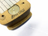 Close-up of vintage John Cruz guitar pickup with visible handwriting and pole piece on white background