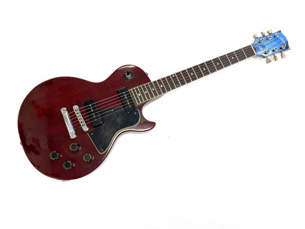 Vintage Gibson Les Paul electric guitar in dark red with black pickguard and two single-coil pickups on white background
