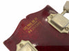 Close-up of Les Paul 55-77 guitar headstock showing serial number and Made in U.S.A. mark on dark red wood with gold lettering and vintage tuning pegs.