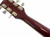 Back of Les Paul guitar headstock with vintage tuning pegs and glossy mahogany neck, close-up view on white background