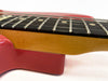 Close-up of guitar neck and fretboard showing detailed wood grain and metal frets on red electric guitar body