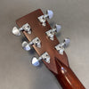 Close-up of guitar headstock back showing chrome Grover tuning pegs on mahogany wood neck against gray background