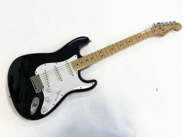 Black Fender Stratocaster electric guitar with maple fretboard and white pickguard on white background