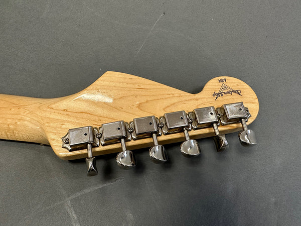 Close-up of maple guitar headstock back with six chrome tuning pegs on grey background, vintage style Custom Shop USA model