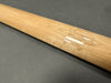 Close-up of a natural maple guitar neck with birdseye wood pattern and glossy finish on a gray background