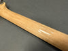 Close-up view of maple guitar neck with birdseye grain pattern on dark gray background