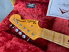Fender Stratocaster maple neck headstock with vintage tuning pegs in red plush guitar case with Fender certification paper and case label visible