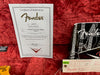 Fender Certificate of Authenticity for Vintage Stratocaster Relic model R33150 dated 04/16/07, displayed on red plush guitar case interior with Fender inspection tag and branded paperwork.