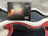Gibson USA owner's manual resting on plush white case lining next to red electric guitar body with black pickguard and control knob
