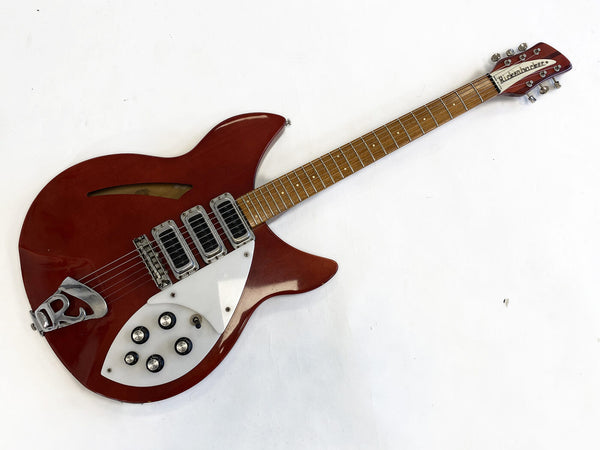 Vintage red Rickenbacker electric guitar with four pickups and white pickguard on white background