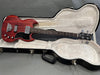 Gibson SG-style electric bass guitar in cherry red finish with black pickguard in open black hardshell guitar case with plush white interior lining