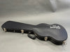 Black Gibson USA hard shell guitar case with metal latches and padded handle on gray background
