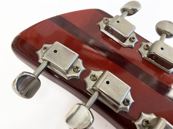 Close-up of vintage metal tuning pegs on mahogany guitar headstock with dark wood stripe and white background for Coffee House Guitars product listing.