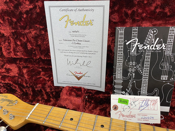 Fender Certificate of Authenticity for Telecaster Pro Closet Classic guitar dated 04/05/11 with Fender Custom Shop tag and guitar neck on red plush guitar case interior