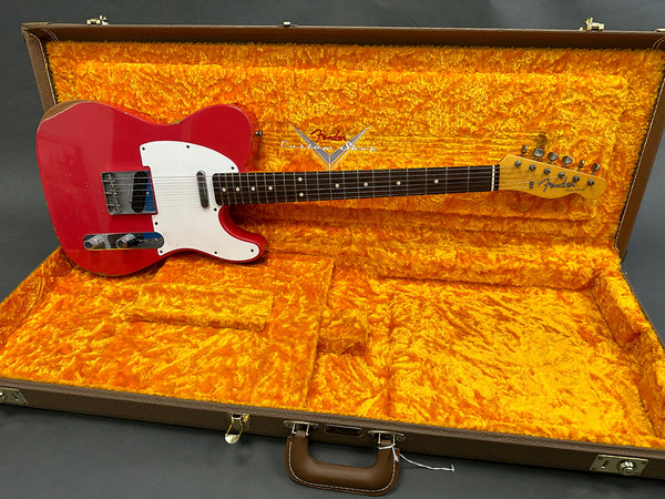 Vintage red Fender Telecaster electric guitar with white pickguard in orange plush-lined Fender Custom Shop hard case