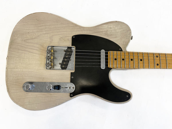 Vintage cream electric guitar with black pickguard and maple fretboard showing worn finish and checking patterns on body