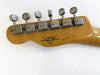 Close-up of Fender Custom Shop guitar headstock with six vintage tuning machines and serial number handwritten on maple wood neck