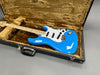 Fender Stratocaster electric guitar with glossy blue finish and maple neck in brown fur-lined black hard case on gray background