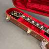 Greco electric guitar neck and headstock with pearl inlays inside brown hard case with red plush interior lining and gold latches