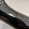 Close-up of black guitar body with visible crack and surface scratches on glossy finish