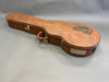 Brown Gibson USA hard guitar case with metal latches and handle on gray background
