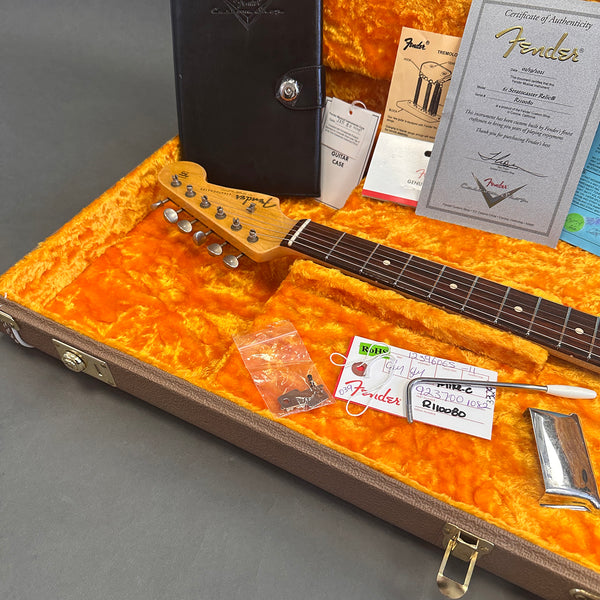 Fender Stratocaster Relic guitar neck inside orange plush lined brown hard case with Fender certificate of authenticity and accessories