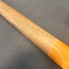 Close-up of smooth satin finished mahogany guitar neck transitioning to glossy maple heel on gray background