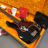 Black Fender Precision Bass guitar with tortoiseshell pickguard in vintage orange lined hard case with Fender paperwork and black Fender accessory pouch