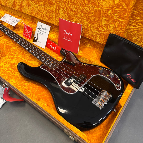 Black Fender Precision Bass guitar with tortoiseshell pickguard in vintage orange lined hard case with Fender paperwork and black Fender accessory pouch