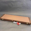 Fender vintage style brown guitar hard case with leather texture and metal latches on gray background