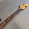 Fender Precision Bass guitar neck with rosewood fingerboard and vintage-style tuning pegs on gray background