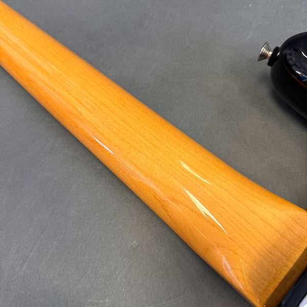 Close-up of smooth, glossy maple guitar neck and black guitar body against gray background, Coffee House Guitars product image