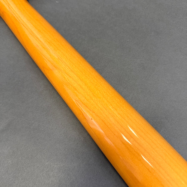 Close-up of glossy finished maple guitar neck on gray background