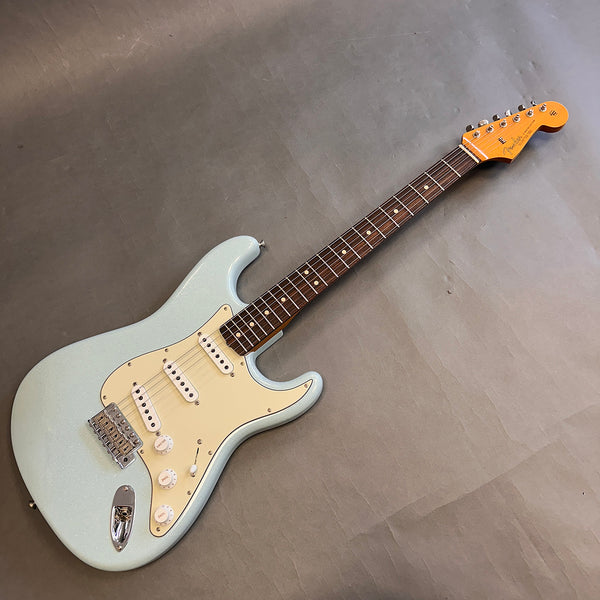 Fender Stratocaster electric guitar with light blue finish, rosewood fretboard, and cream pickguard on grey background