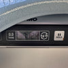 Digital scale close-up showing guitar weight as 7 pounds 12.4 ounces with tare and hold buttons visible