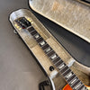 Greco electric guitar neck with mother of pearl block inlays and vintage tuners inside a plush lined hard case on a gray surface