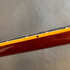 Close-up image of guitar neck side showing fret wire, yellow binding, dot fret marker, and polished wood finish