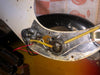 Close-up of vintage electric guitar potentiometer and wiring under the pickguard showing capacitors and soldered connections on a sunburst body guitar
