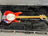 Red Music Man Stingray 4 electric bass guitar with maple neck and white pickguard in black plush-lined hard case