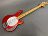 Red electric bass guitar with maple neck and white pickguard on gray background from Coffee House Guitars