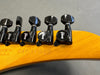 Close-up of Gibson guitar headstock tuning pegs with serial number 940313 and "Made in U.S.A." stamped on wood
