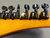 Close-up of Gibson guitar headstock showing black Gibson tuning pegs and serial number 94031313 with Made in USA stamp on maple wood neck