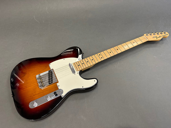 Fender Telecaster electric guitar with sunburst finish and maple neck on gray background