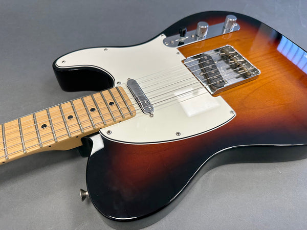 Electric guitar with sunburst finish, maple neck, white pickguard, and chrome hardware on gray background from Coffee House Guitars